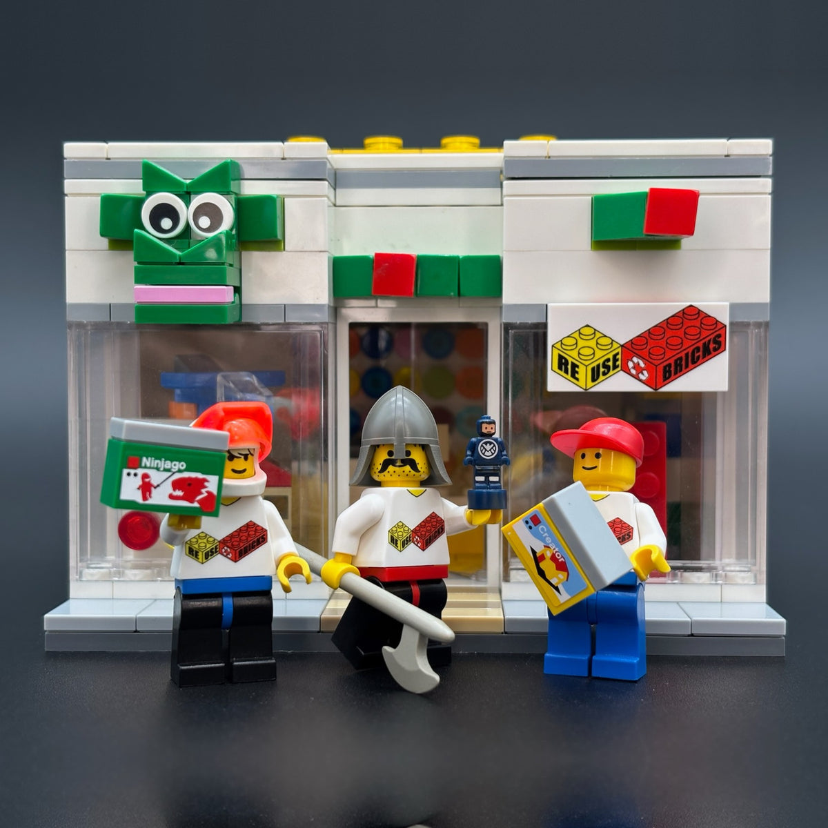 LEGO Store model with three minifigures in ReUseBricks shirts out front